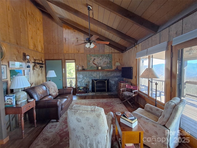 living room featuring a wealth of natural light, wood-type flooring, wooden walls, lofted ceiling with beams, and wooden ceiling