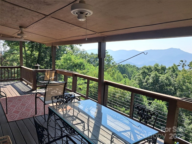 deck with ceiling fan and a mountain view