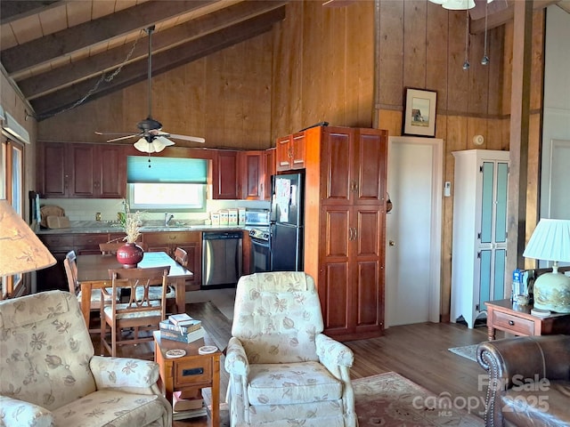 kitchen with black fridge, stainless steel dishwasher, wood-type flooring, sink, and range