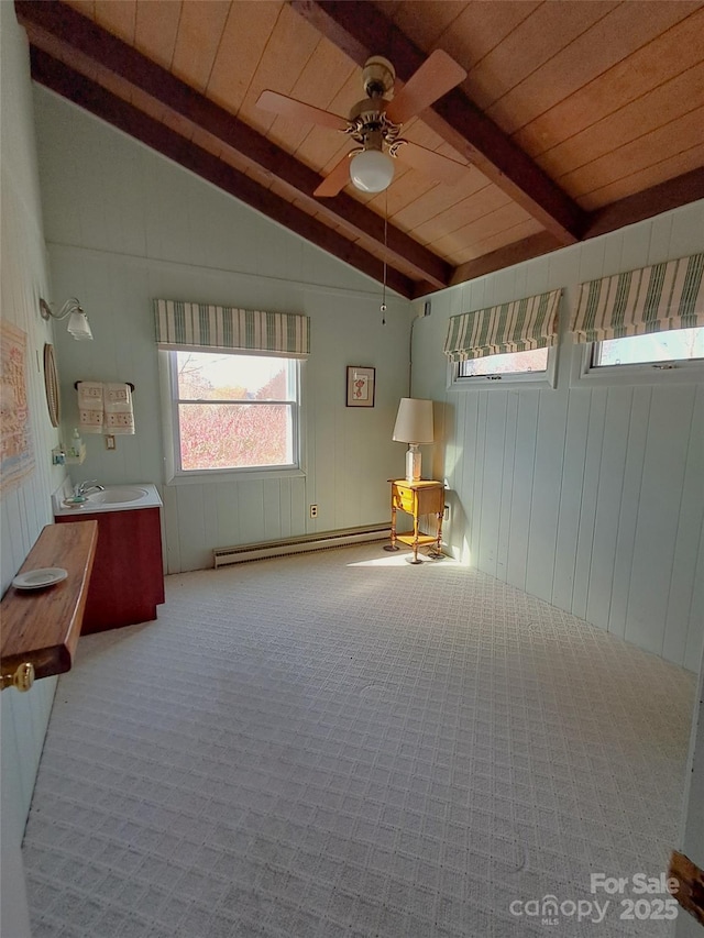 interior space featuring a baseboard heating unit, ceiling fan, wood ceiling, and lofted ceiling with beams