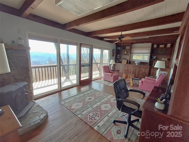 office with ceiling fan, beamed ceiling, and hardwood / wood-style floors