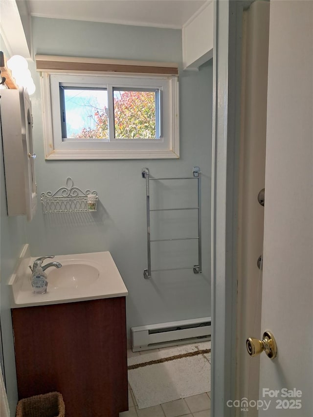 bathroom featuring baseboard heating, tile patterned floors, and vanity