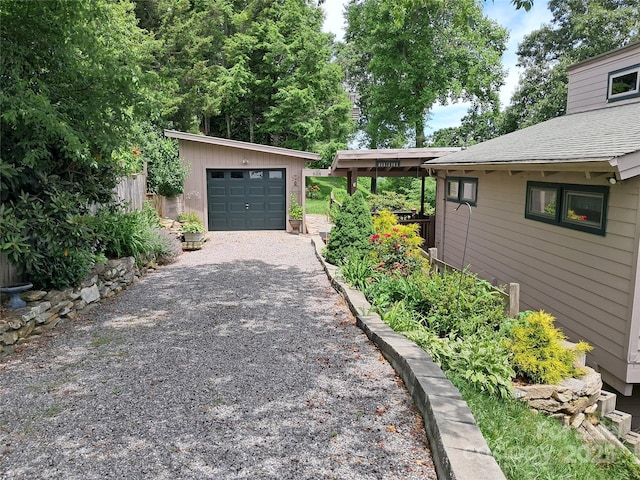 view of property exterior featuring an outdoor structure and a garage