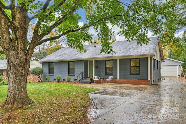 ranch-style house with an outbuilding, a garage, and a front lawn