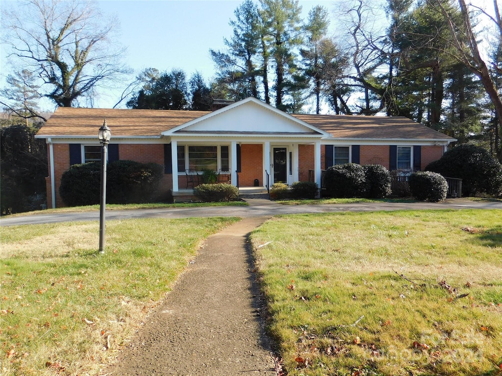 view of front of home with a front lawn and a porch