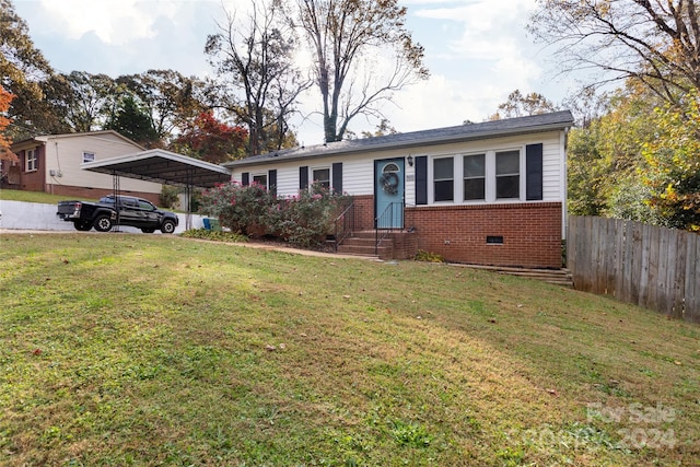 single story home featuring fence, a front lawn, brick siding, entry steps, and a carport