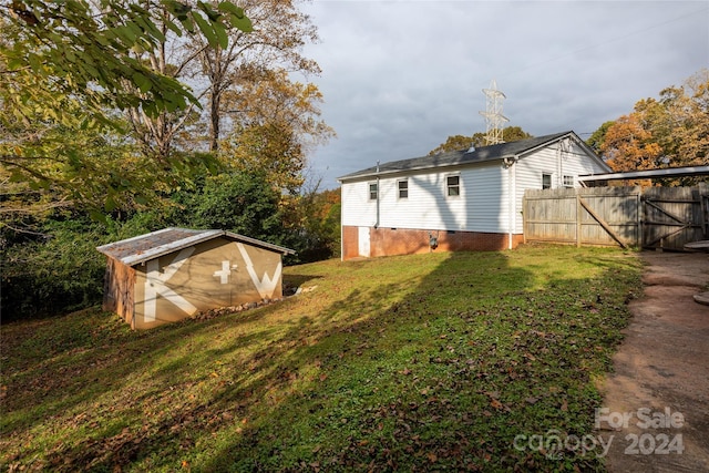 view of yard featuring an outdoor structure and fence