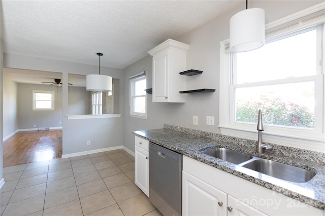 kitchen with sink, dishwasher, pendant lighting, and white cabinets