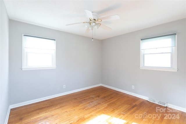 empty room featuring ceiling fan and hardwood / wood-style flooring