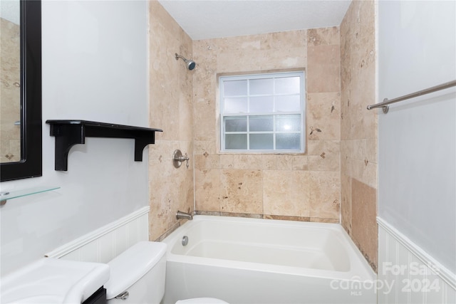 full bathroom with a decorative wall, toilet, a wainscoted wall, and bathtub / shower combination