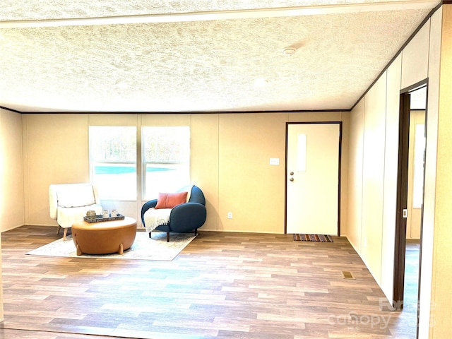 sitting room featuring a textured ceiling and light hardwood / wood-style flooring