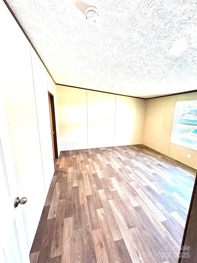 empty room featuring hardwood / wood-style floors and a textured ceiling