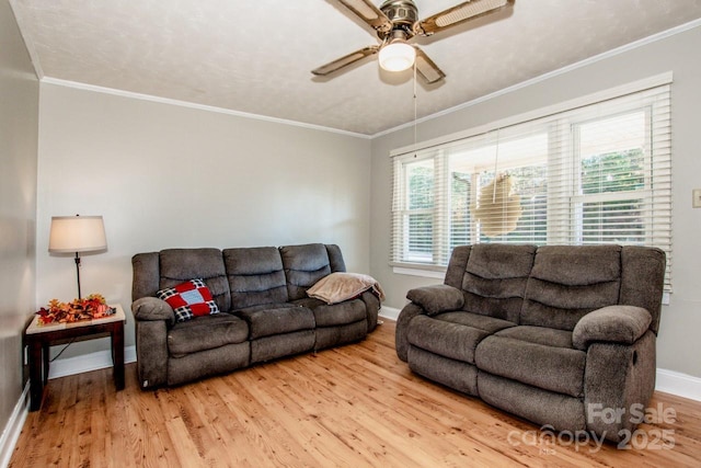 living room featuring ceiling fan, wood-type flooring, and crown molding