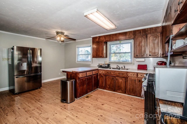 kitchen featuring crown molding, kitchen peninsula, stainless steel refrigerator with ice dispenser, and light wood-type flooring