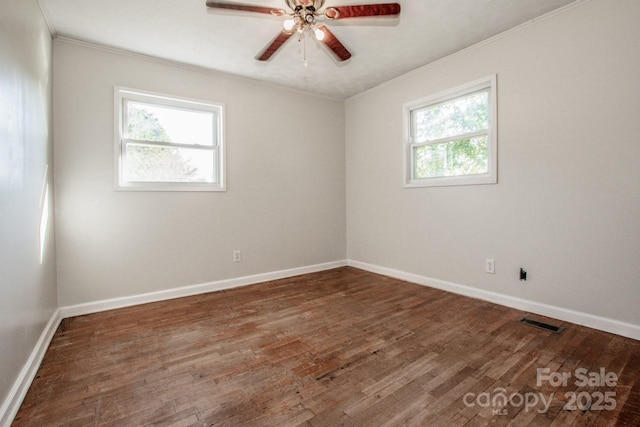 unfurnished room with ceiling fan, dark hardwood / wood-style flooring, and ornamental molding