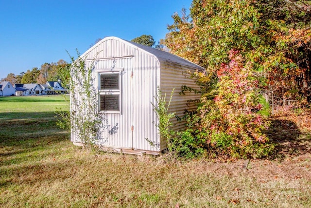 view of outbuilding with a yard