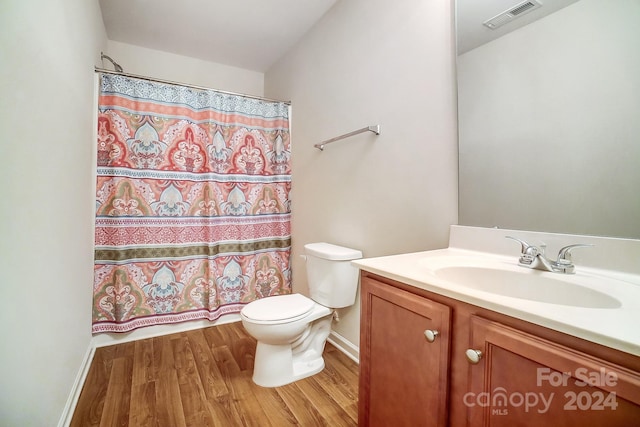 bathroom with vanity, toilet, hardwood / wood-style flooring, and a shower with shower curtain