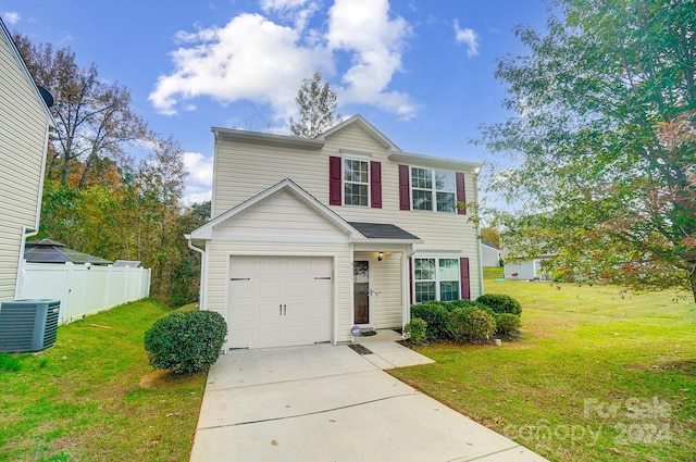 view of front of home featuring central air condition unit, a front lawn, and a garage