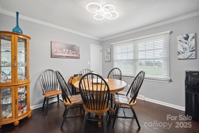 dining space with a textured ceiling, dark wood-type flooring, and crown molding