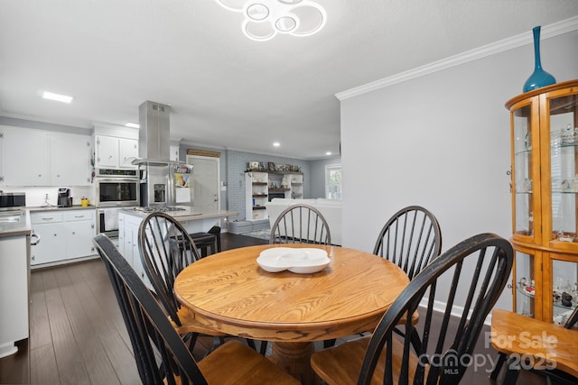 dining area featuring ornamental molding and dark wood-type flooring