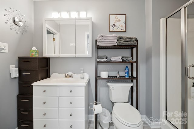 bathroom with vanity, toilet, and an enclosed shower