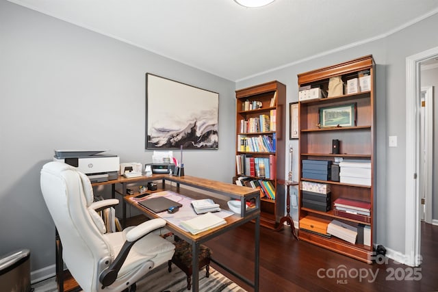 office area with dark wood-type flooring and ornamental molding