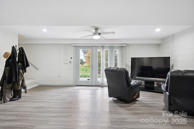 living room featuring ceiling fan and light hardwood / wood-style flooring