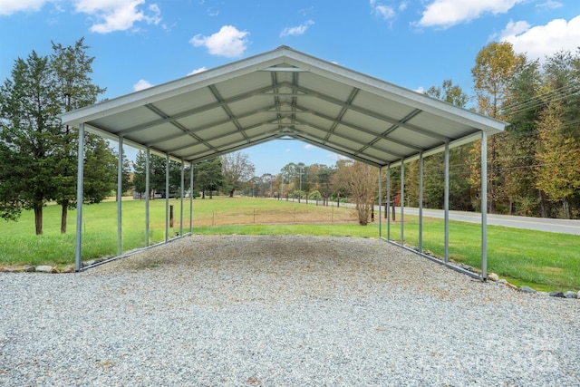 view of parking featuring a yard and a carport