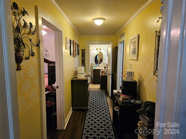 corridor with ornamental molding, a textured ceiling, and dark hardwood / wood-style flooring