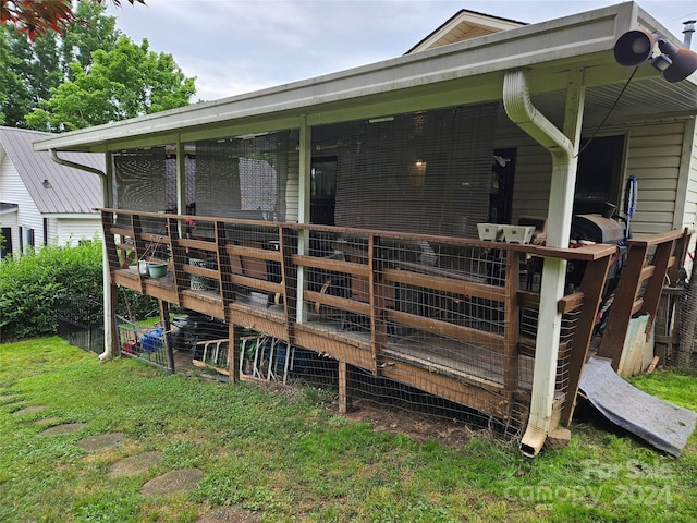 rear view of property featuring an outbuilding