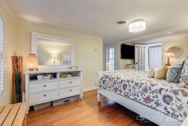 bedroom featuring crown molding and light wood-type flooring