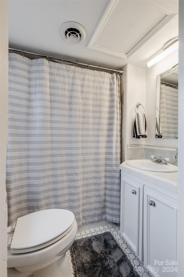 bathroom featuring vanity, toilet, tile patterned floors, and walk in shower