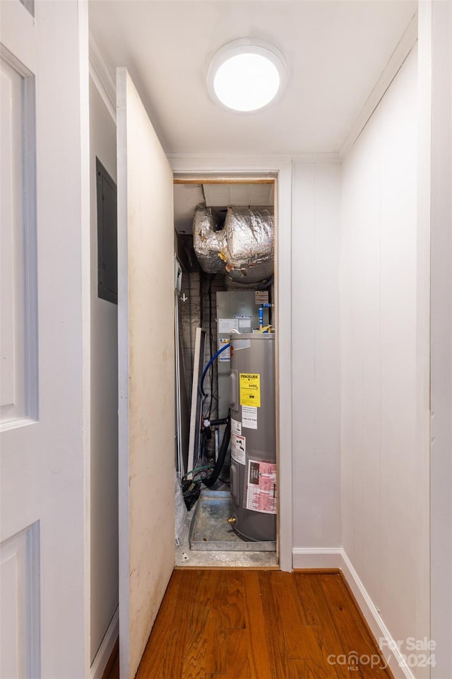 utility room featuring water heater and electric panel