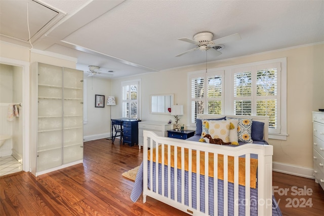 bedroom with a textured ceiling, crown molding, dark hardwood / wood-style floors, and ceiling fan