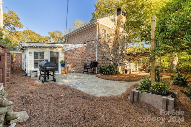 rear view of property featuring a patio area