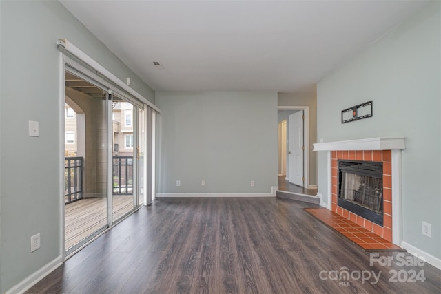 unfurnished living room with a fireplace and dark hardwood / wood-style floors