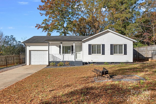 ranch-style home featuring a front yard, a porch, and a garage