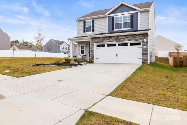 view of front of home featuring a garage and a front yard