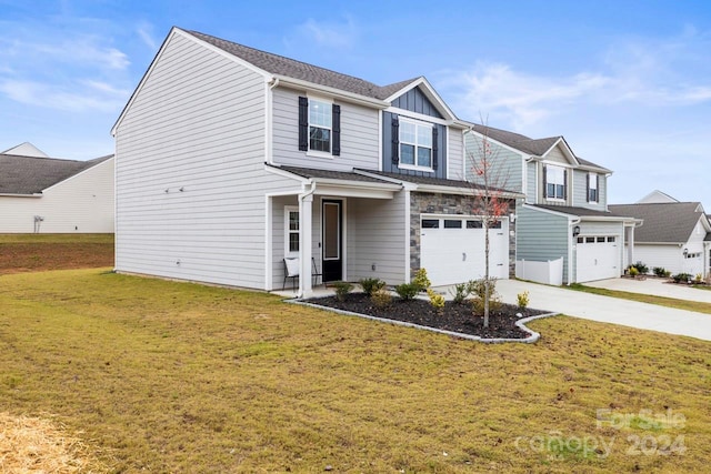 view of front of property featuring a garage and a front lawn