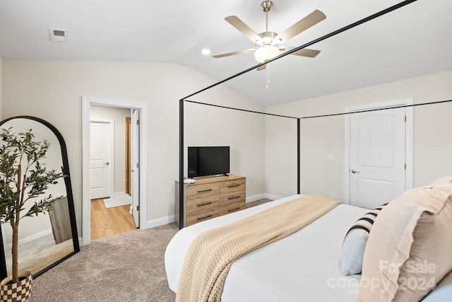 carpeted bedroom with ceiling fan, a closet, and lofted ceiling