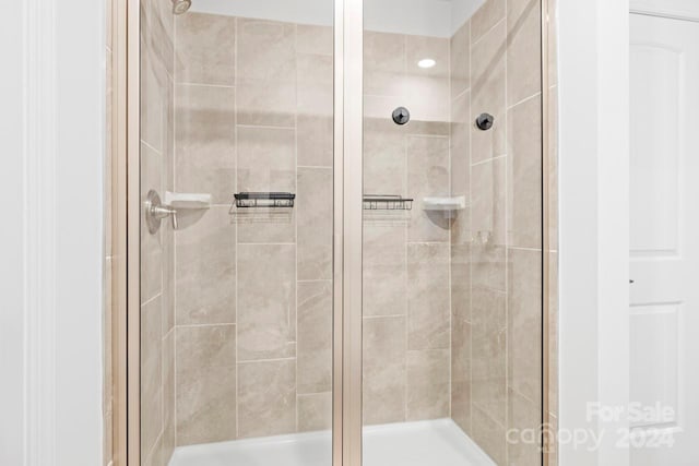 bathroom with a shower with shower door