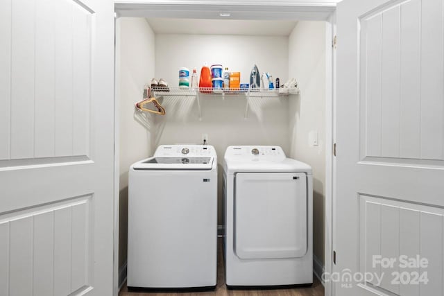 laundry room featuring hardwood / wood-style flooring and washer and dryer