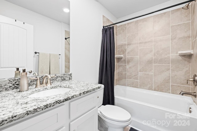 full bathroom with vanity, toilet, and shower / bath combination with curtain