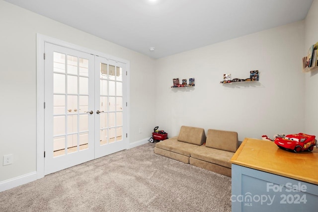 living room featuring french doors and carpet