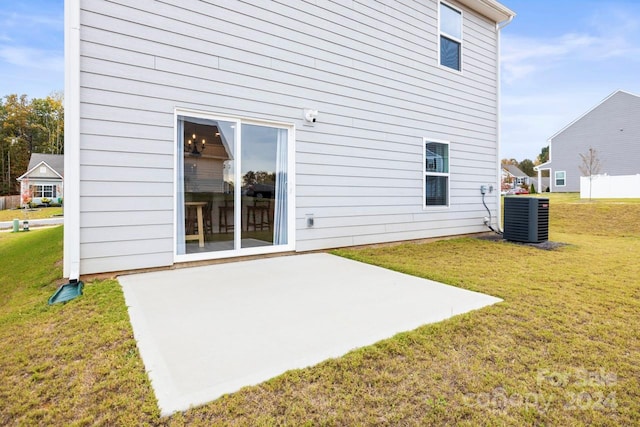 back of house with a patio area, cooling unit, and a yard