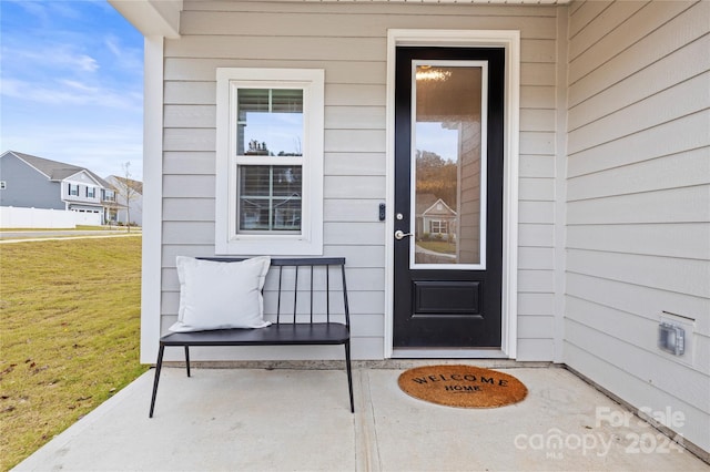 entrance to property with a lawn