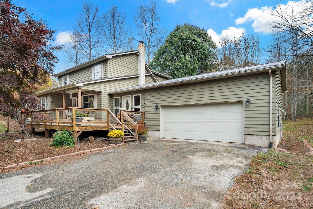 view of front of home featuring a deck and a garage