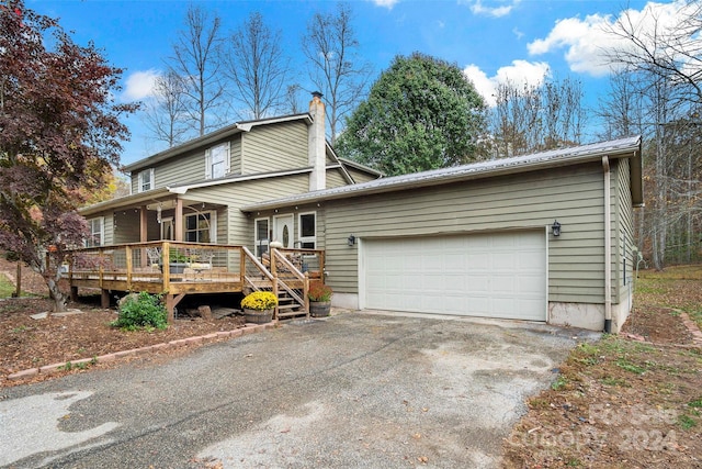 view of front of home featuring a deck and a garage