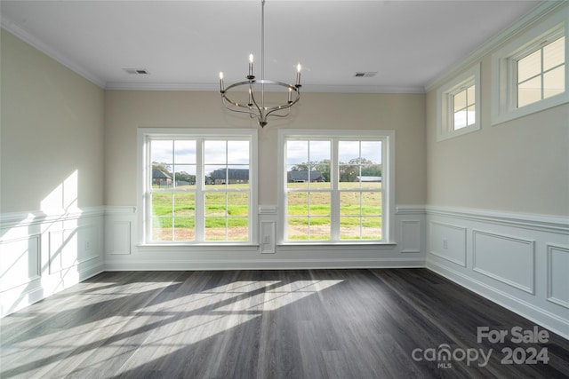 unfurnished dining area with dark wood-type flooring, an inviting chandelier, and ornamental molding