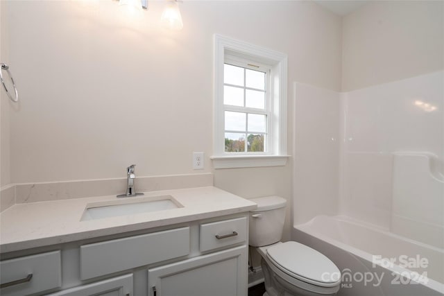 full bathroom with  shower combination, vanity, and toilet